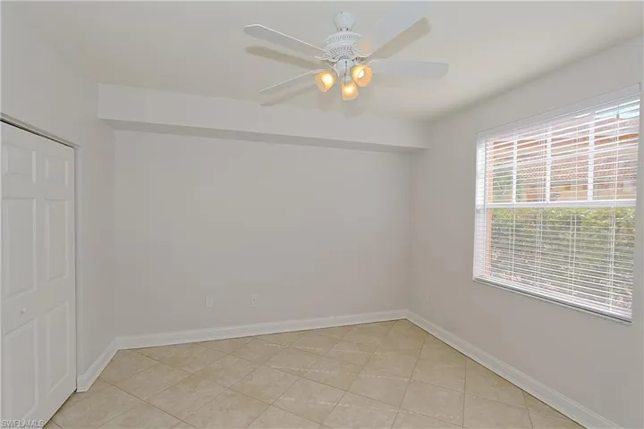 Unfurnished room featuring a ceiling fan and light tile patterned floors