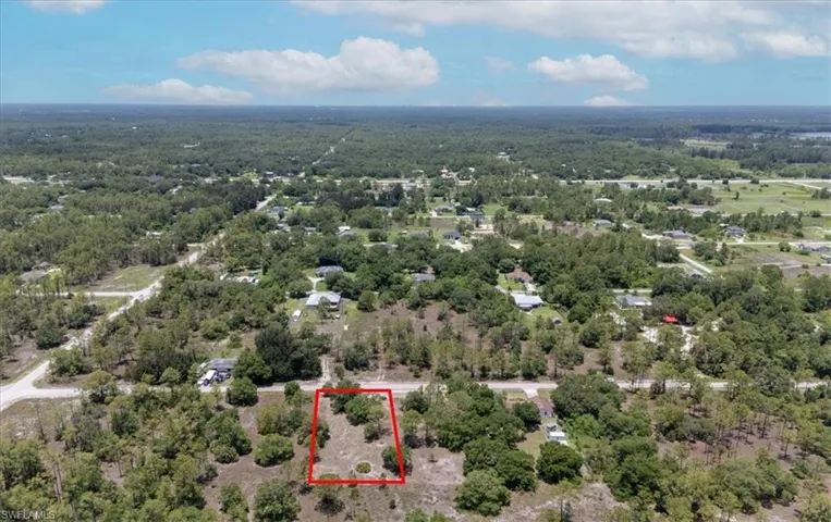 Aerial overview of property's location featuring property parcel outlined and a forest