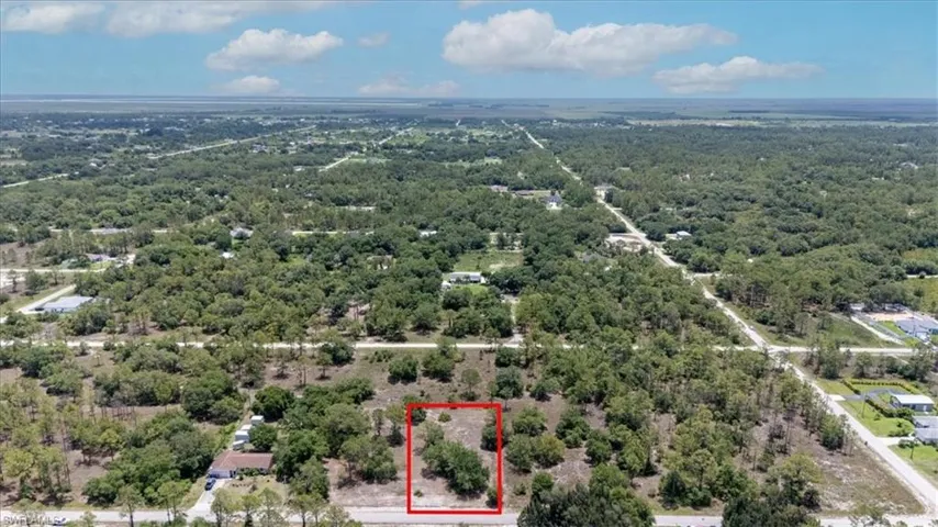 View of property location with property boundaries highlighted and a forest