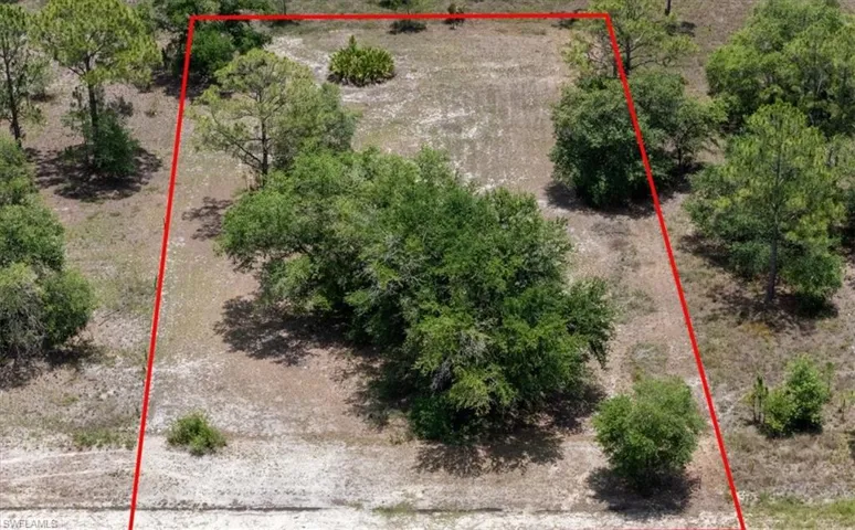 Aerial view of property and surrounding area with property parcel outlined
