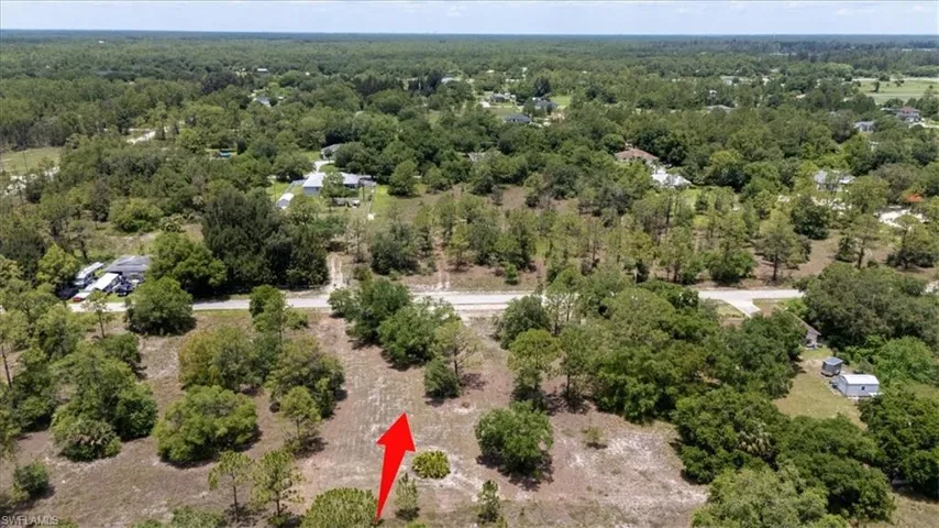 View of property location featuring a forest