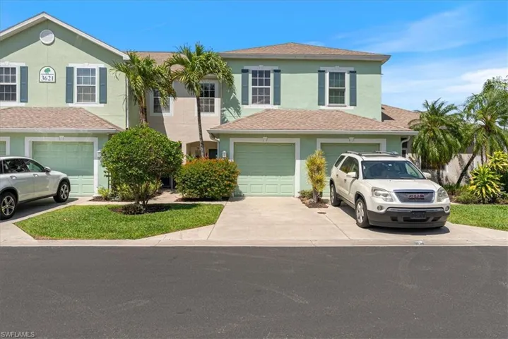 View of front facade featuring driveway and stucco siding