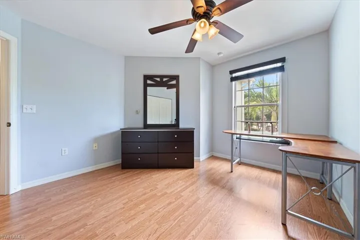 Home office featuring light wood-style flooring, baseboards, and a ceiling fan