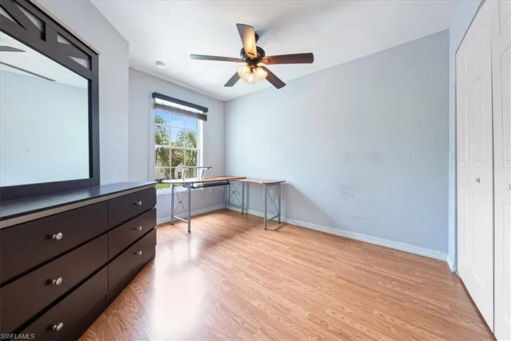 Unfurnished office featuring light wood finished floors, baseboards, and ceiling fan