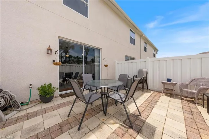 View of patio featuring fence and outdoor dining space