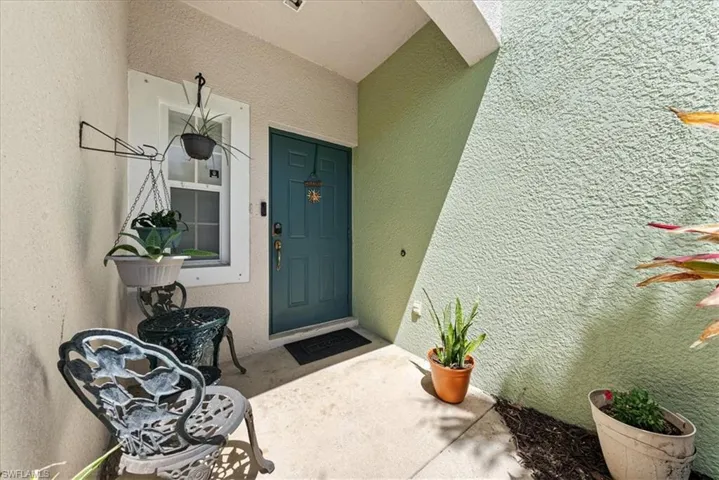 Entrance to property with stucco siding