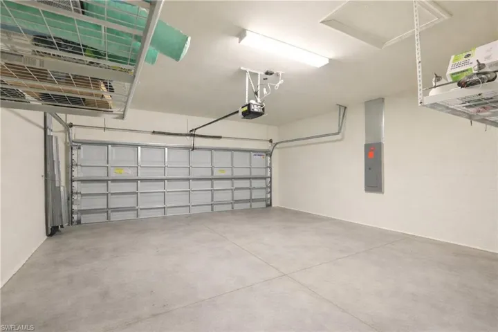 Garage with electric panel and a garage door opener