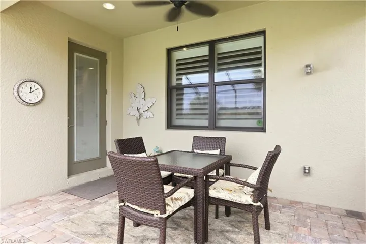 View of patio featuring outdoor dining area and ceiling fan