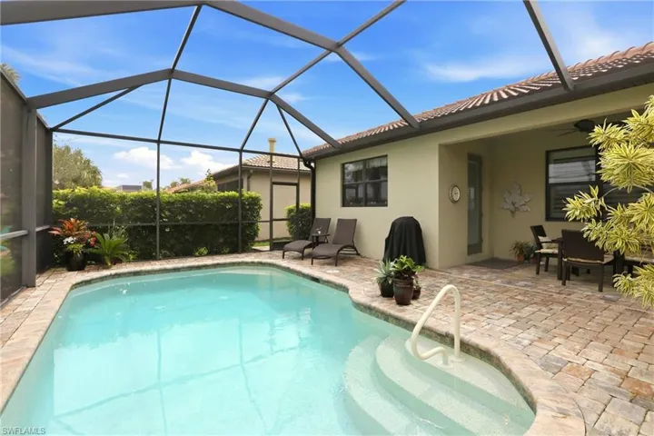 Outdoor pool with a lanai, a sunroom, and a patio area.  Neither neighbor has a pool, so you have complete privacy.
