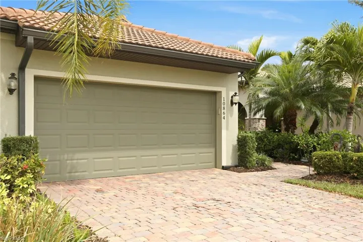 Garage with decorative brick paver driveway