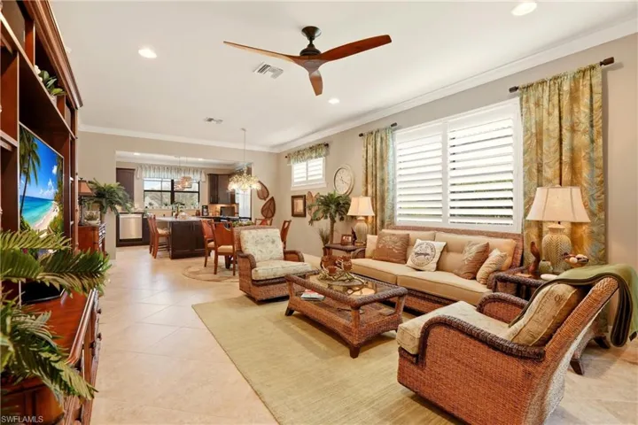 Living area with a view to the kitchen which overlooks the pool and lake.