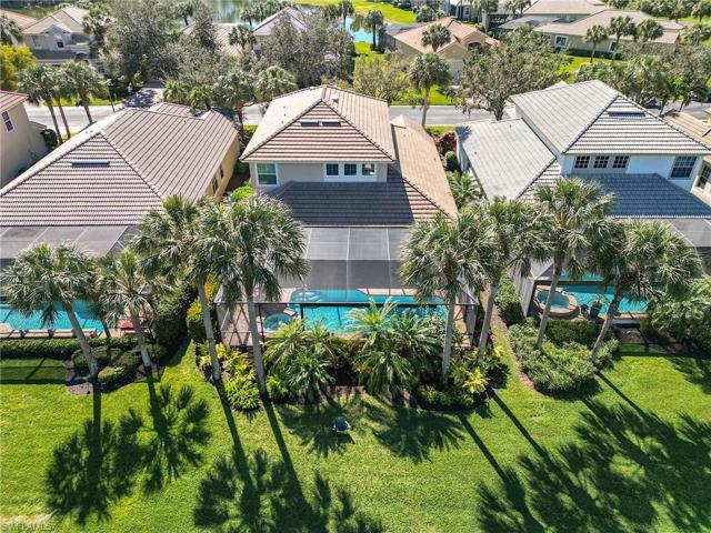 The Rear Aeiral view reflects mature palm trees and grassy area next to the water.... beauty abounds!