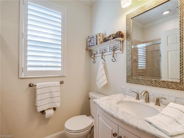 This second floor full bath offers a tile walk-in shower, upgraded cabinet, mirror, countertop.