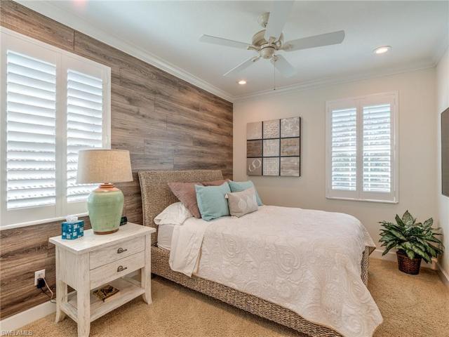 Second floor bedroom #2 offers a walk-in closet with and a decorative accent wall, plantations shutters