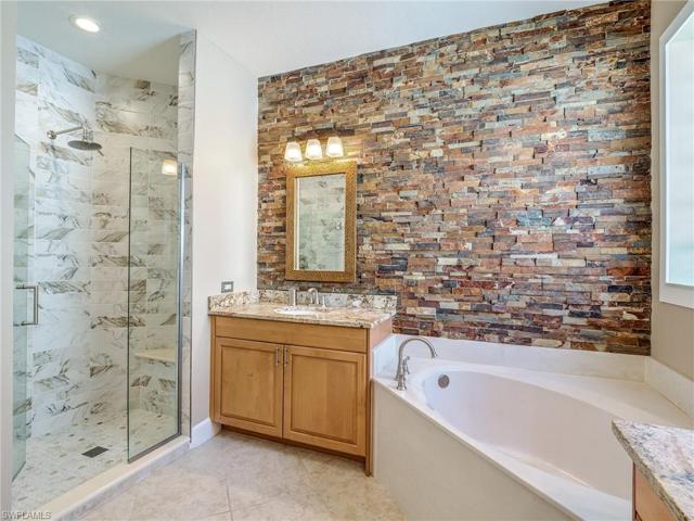 Upgraded full tile Walk-in shower with bench seat.