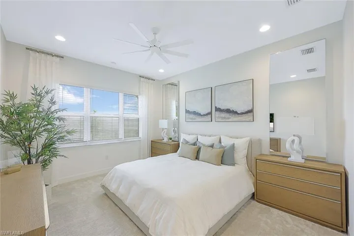 Bedroom featuring ceiling fan and light colored carpet