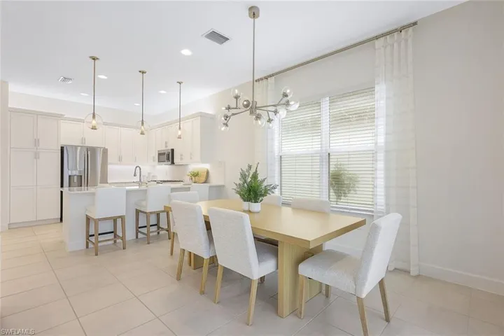Tiled dining area with sink and a chandelier