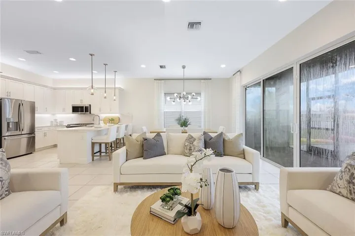 Tiled living room featuring a notable chandelier and sink