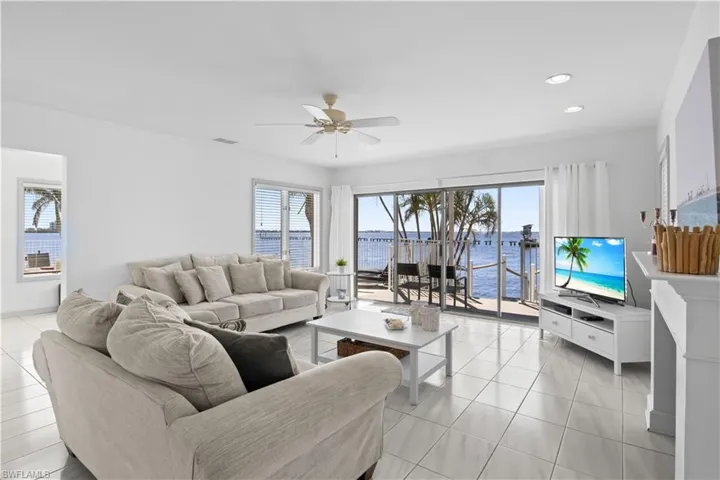 Bright and spacious great room with soaring ceilings, abundant natural light, and direct views of the Caloosahatchee River – perfect for entertaining or relaxing.