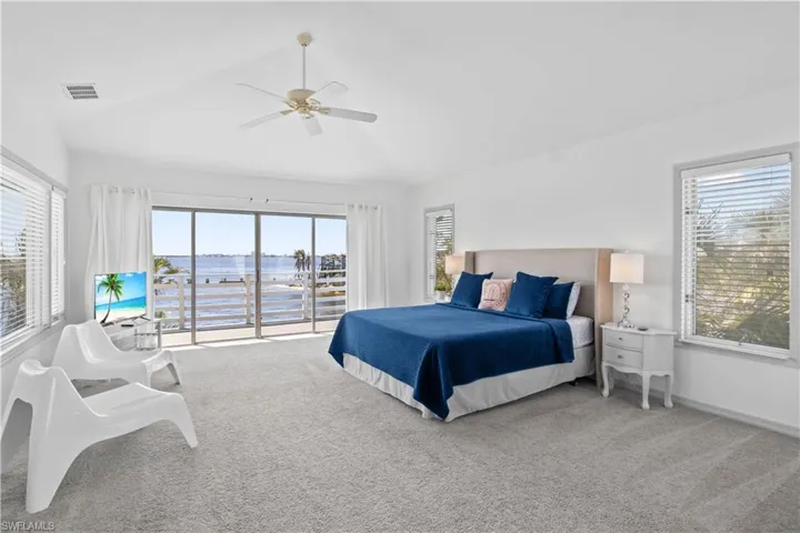 Expansive primary suite with private balcony overlooking the river – enjoy peaceful sunrises and breathtaking sunsets from your own retreat.