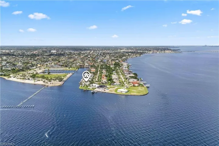 This rare aerial perspective captures the home’s enviable waterfront position – directly on the Caloosahatchee River, with wide canal frontage and unobstructed access to the Gulf. Whether you're arriving by land or water, this property truly stands out.