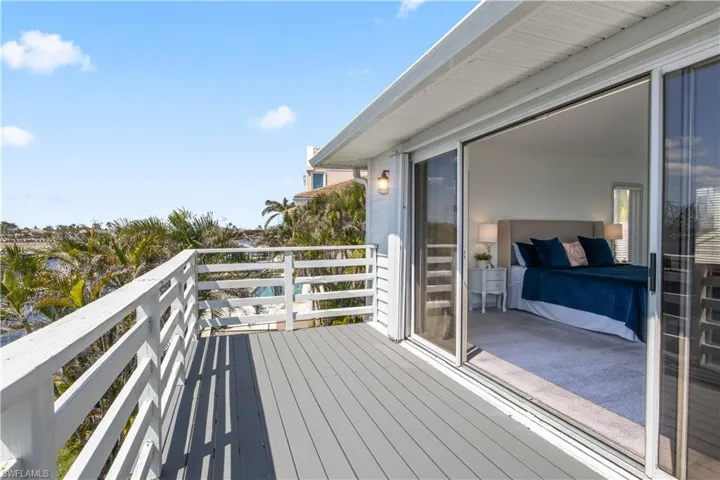 Private upstairs balcony with panoramic water views – your front-row seat to unforgettable sunsets.