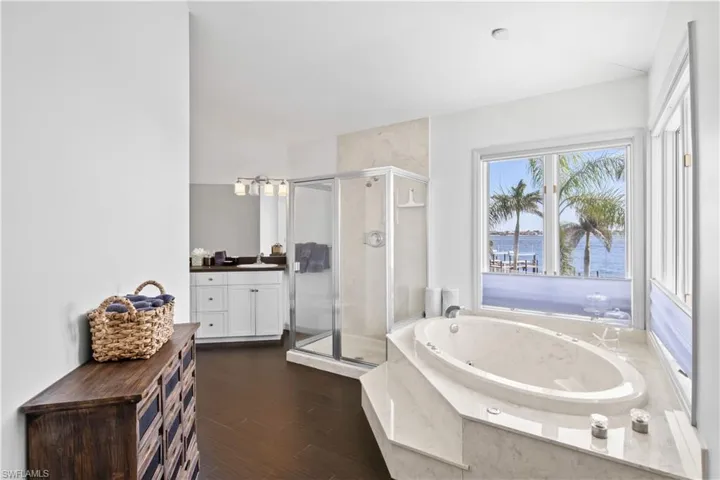 Elegant ensuite bath with double vanities, soaking tub, and walk-in shower – designed for comfort and style.