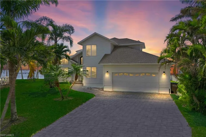 This is what Florida luxury looks like from the front – elegant design, wide lot, and just steps from the water!