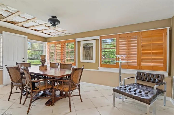 Tiled dining space with ceiling fan