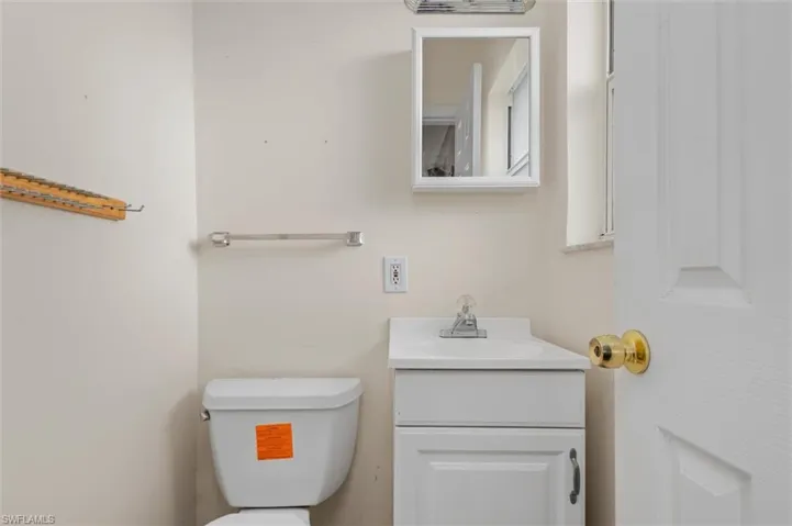 Bathroom featuring toilet and large vanity