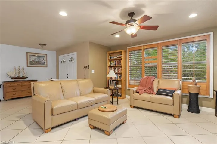 Tiled living room featuring ceiling fan