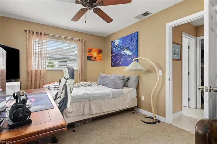Bedroom featuring light carpet and ceiling fan