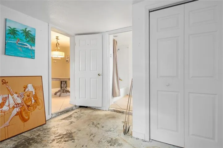 Hallway with concrete floors and a textured ceiling