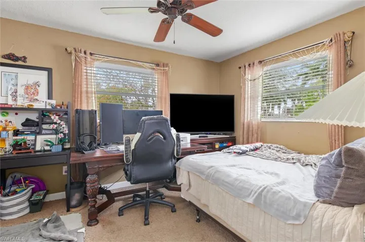 Bedroom with ceiling fan and carpet floors