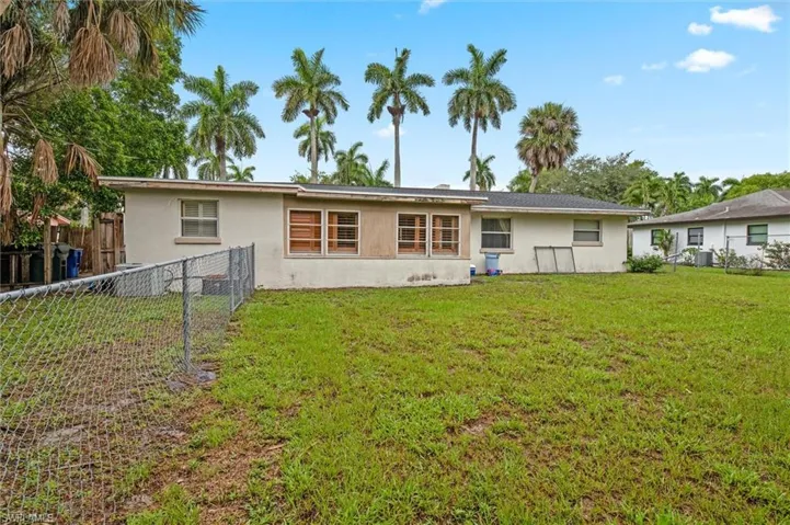 Back of house with a lawn
