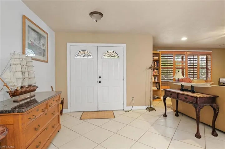 Foyer entrance with light tile flooring