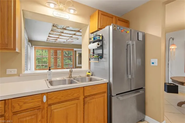 Kitchen with sink, high end fridge, and light tile floors