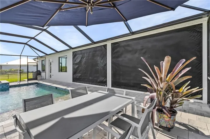 View of swimming pool with a lanai and a patio