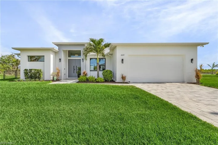 View of front of house featuring a garage and a front yard