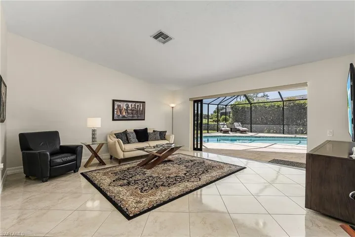 Formal tiled living room with lofted ceiling