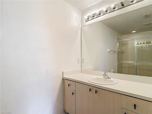 Bathroom with vanity with extensive cabinet space