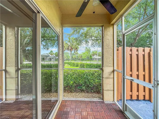 Unfurnished sunroom featuring ceiling fan