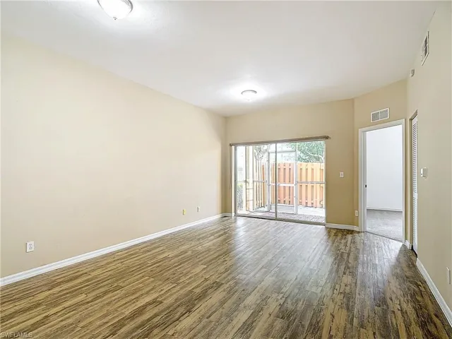 Spare room with dark wood-type flooring