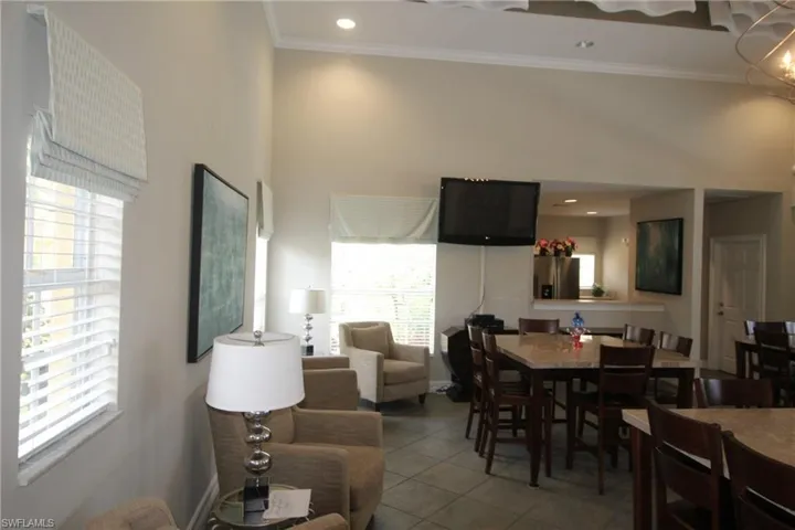 Dining room with tile flooring and ornamental molding