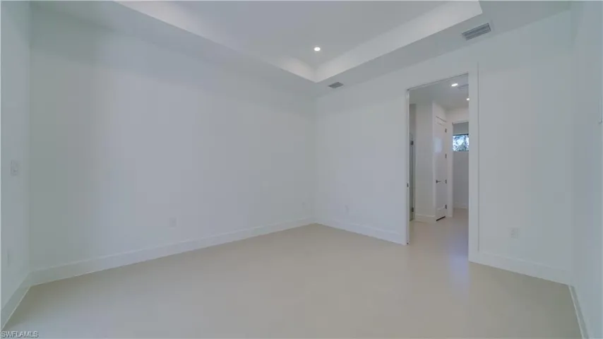 Primary bedroom. 10' tray ceiling with custom lighting.