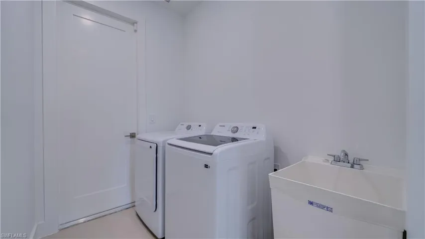 Indoor laundry room with utility sink & Samsung washer & dryer!