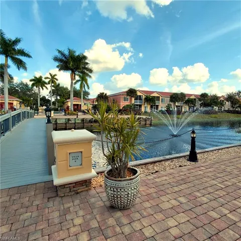 View of property's community with a water view and a patio