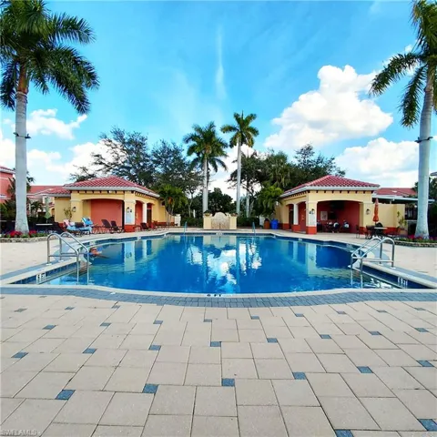 Community pool featuring a patio