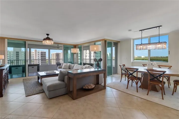 Large living space with sliders to wrap-around lanai, living room, and formal dining.