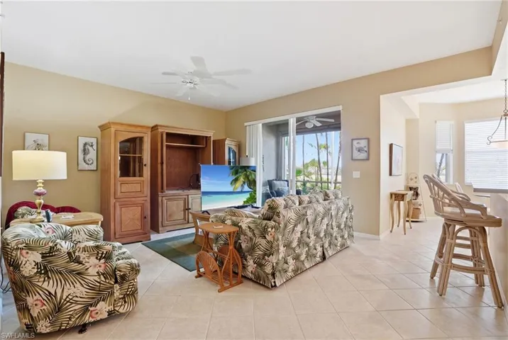 This living area features light-toned tile flooring and neutral-colored walls